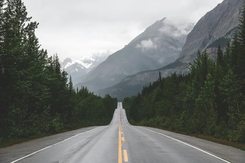 Highway stretching toward misty mountains in BC