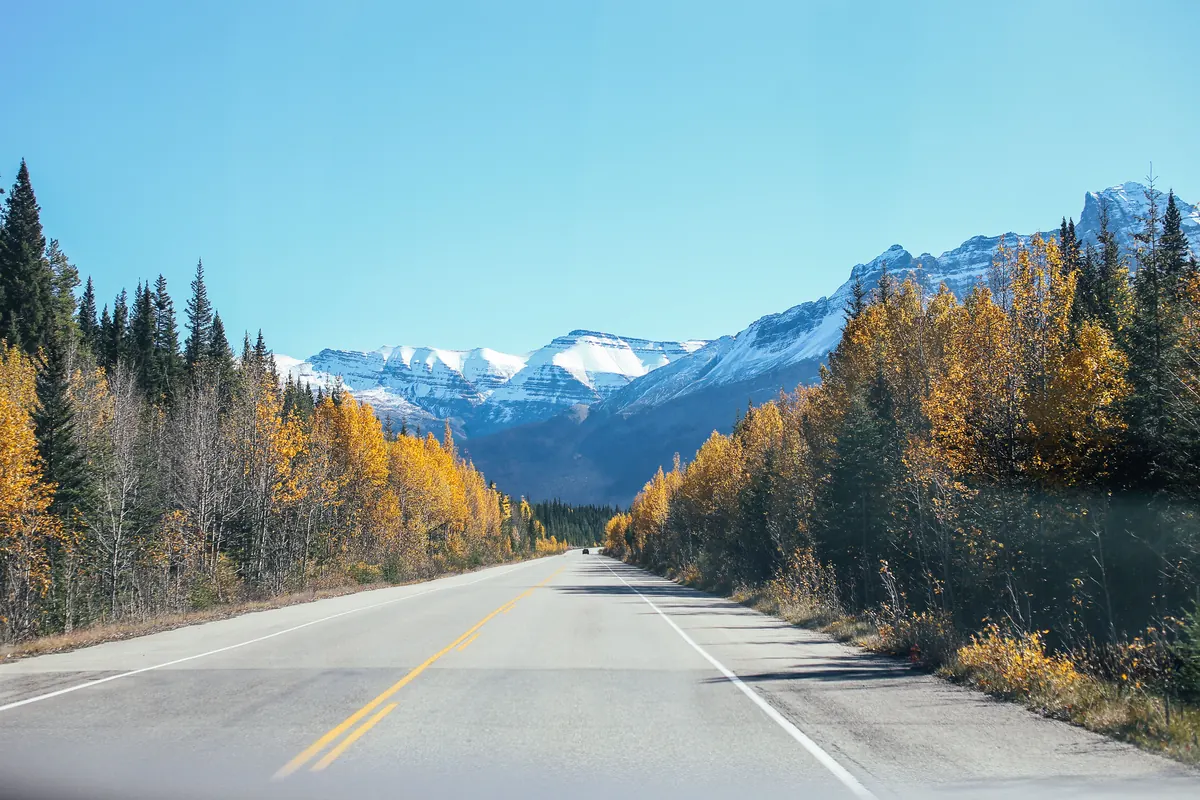Two-lane rural highway in BC with mountains ahead