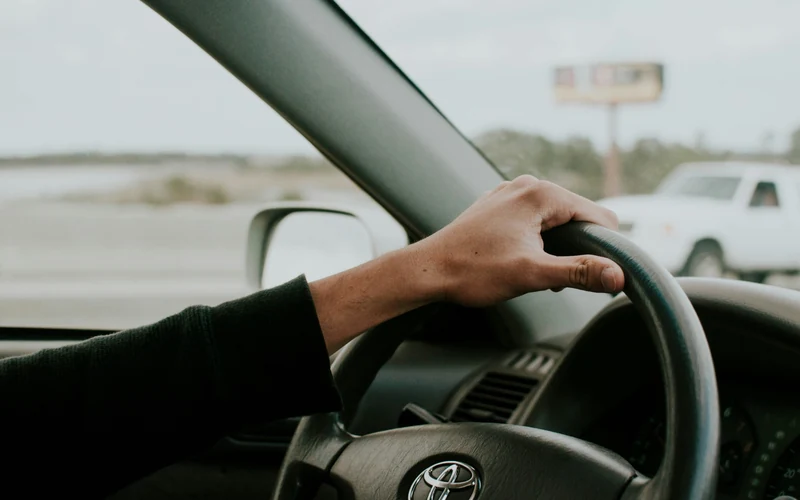 Driver hand on steering wheel for a Class 5 road test guide